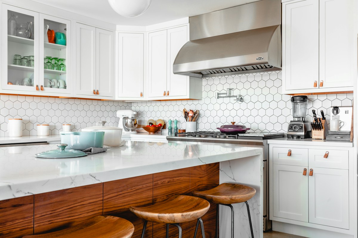 An uncluttered kitchen with warm wood details and clear countertops